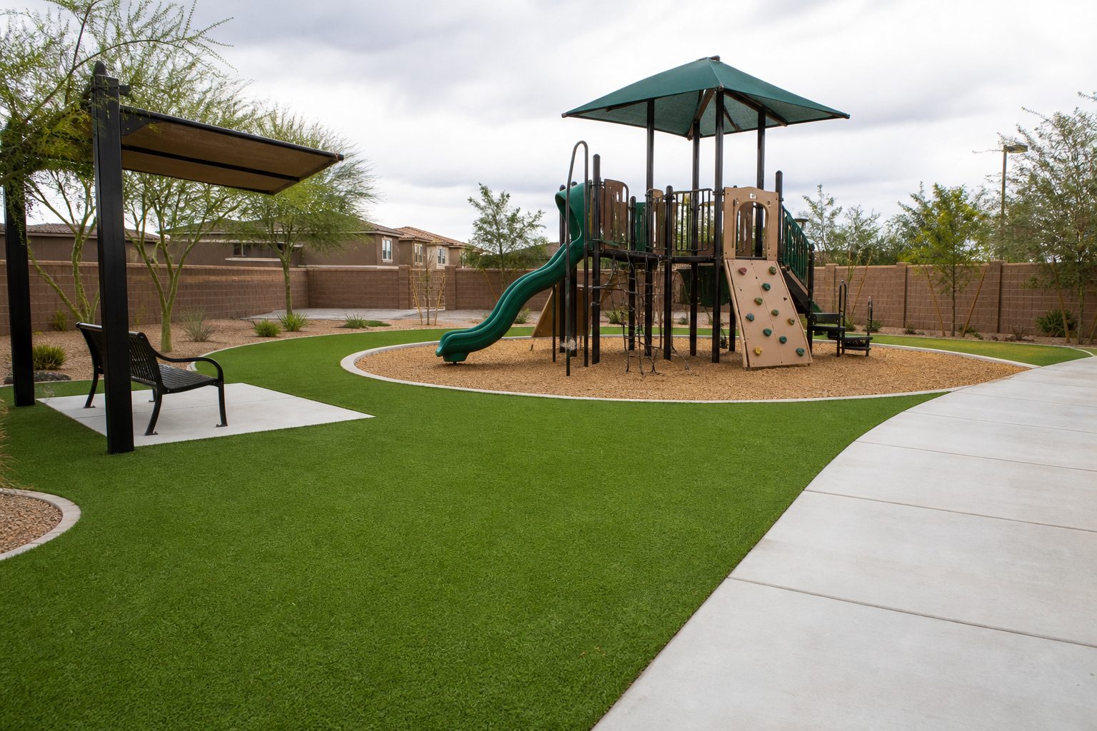 Play area with artificial turf paths around unoccupied equipment